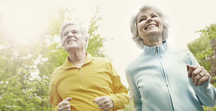 Is there a way to extend the life of hearing aid batteries - A happy senior couple enjoying a brisk jog