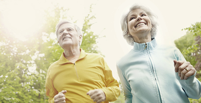 Is there a way to extend the life of hearing aid batteries - A happy senior couple enjoying a brisk jog
