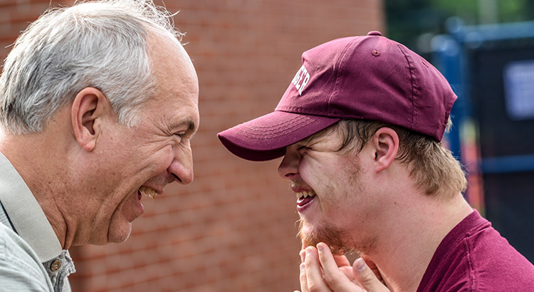 father and son smiling at each other