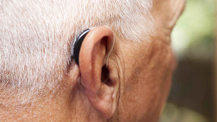 Senior Man's Ear with Hearing Aid