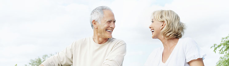 Maximize the Benefits of Your Hearing Aid - couple smiling at each other