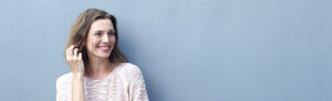 Attractive mid adult woman smiling with hand in hair