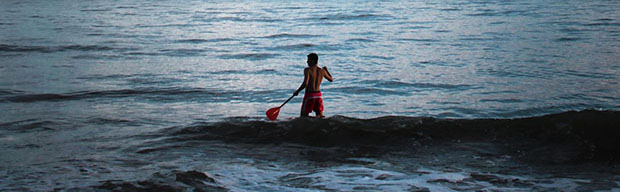 man riding a paddle board