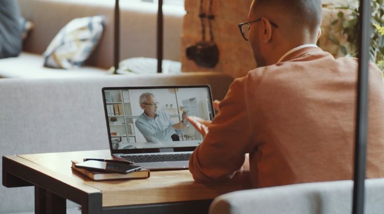 hearing benefits survey - man in front of laptop computer