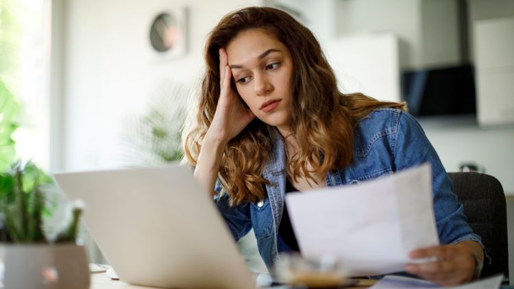 health equity - woman stressed working on laptop