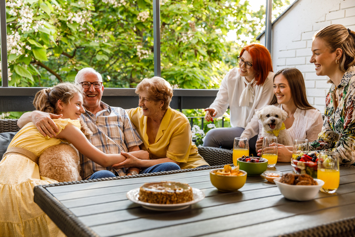 Family sitting on a back deck