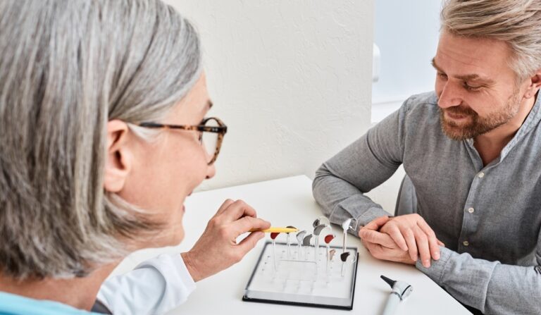 Hearing Provider talking with patient discussing hearing health