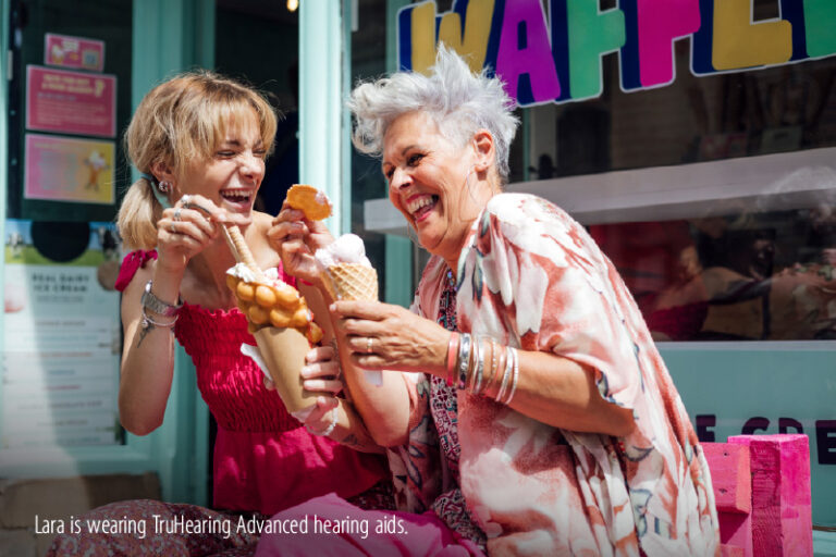 Two women out in the sun, enjoying ice cream