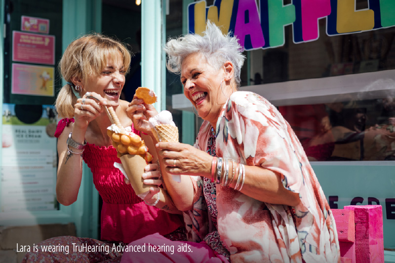 Two women out in the sun, enjoying ice cream