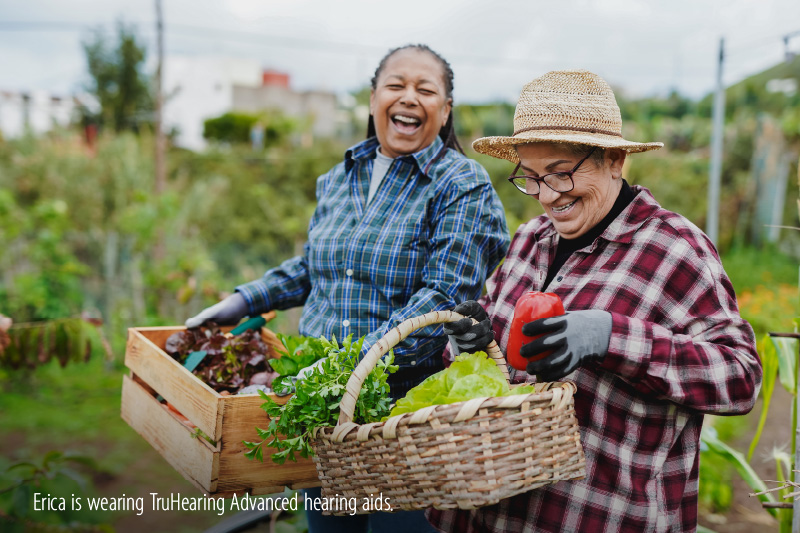 Two women laughing while gardening
