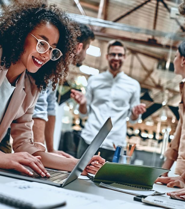 Young business people in office Group of young multiracial business people are working in modern office. Freelancers in coworking place. Creative and stylish youth.